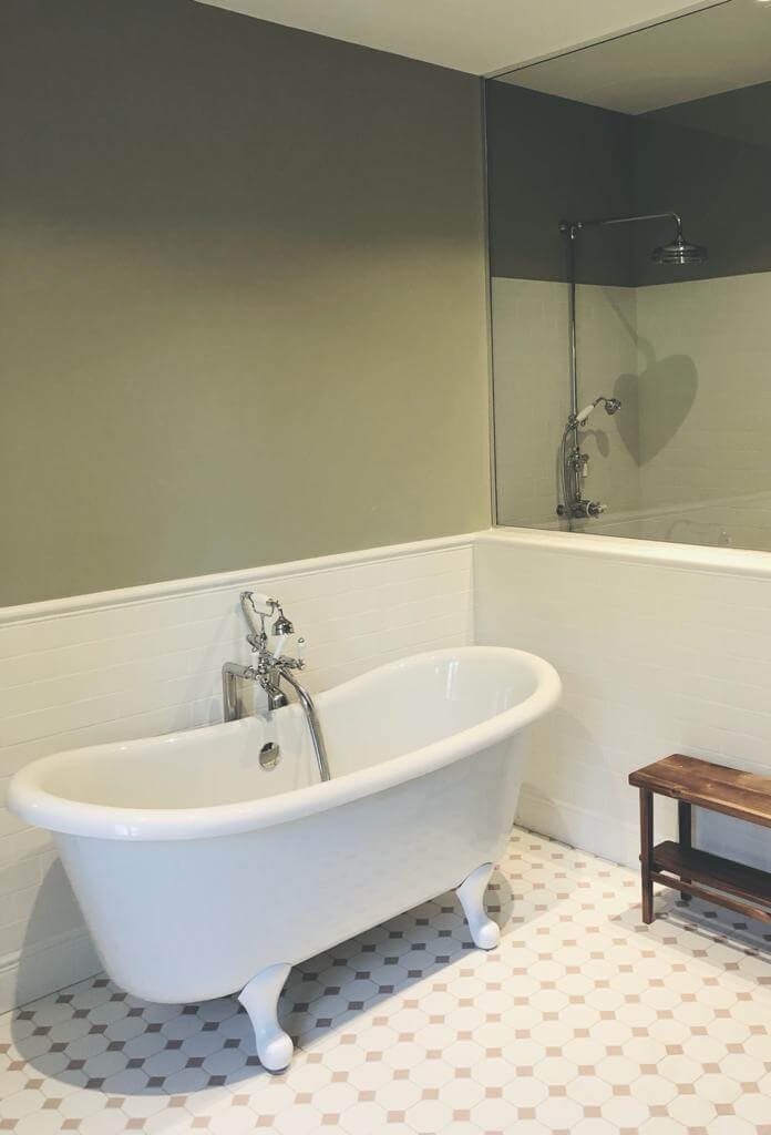 Paris luxury bathroom with elegant freestanding bathtub and refined finishes, designed for international property owners.