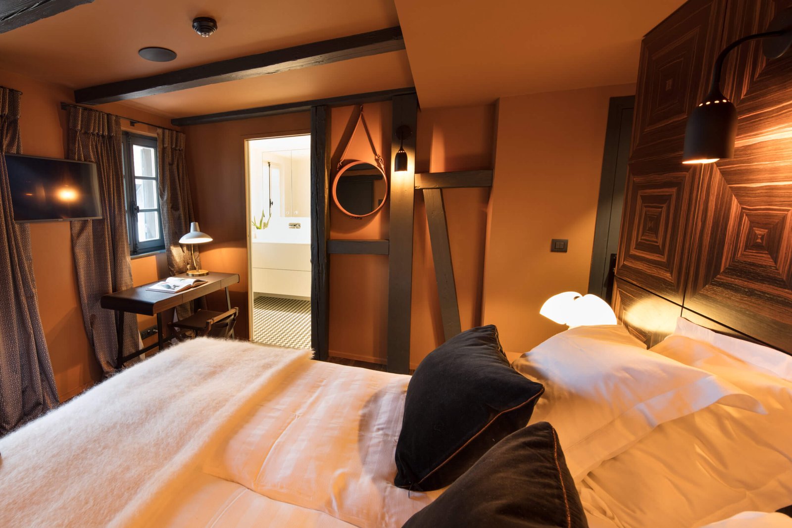 Luxury bedroom in Paris with refined wood design and warm lighting, created by Paris interior designer Charles-Eric Guerrier.