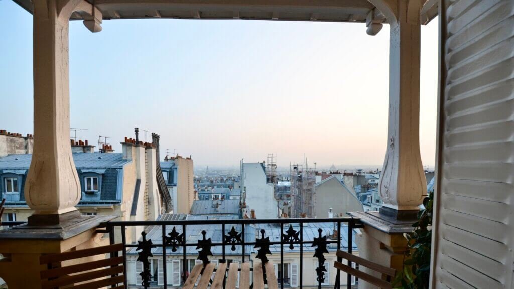 View over Paris rooftops from a balcony – Paris interior designer, exclusive apartment design