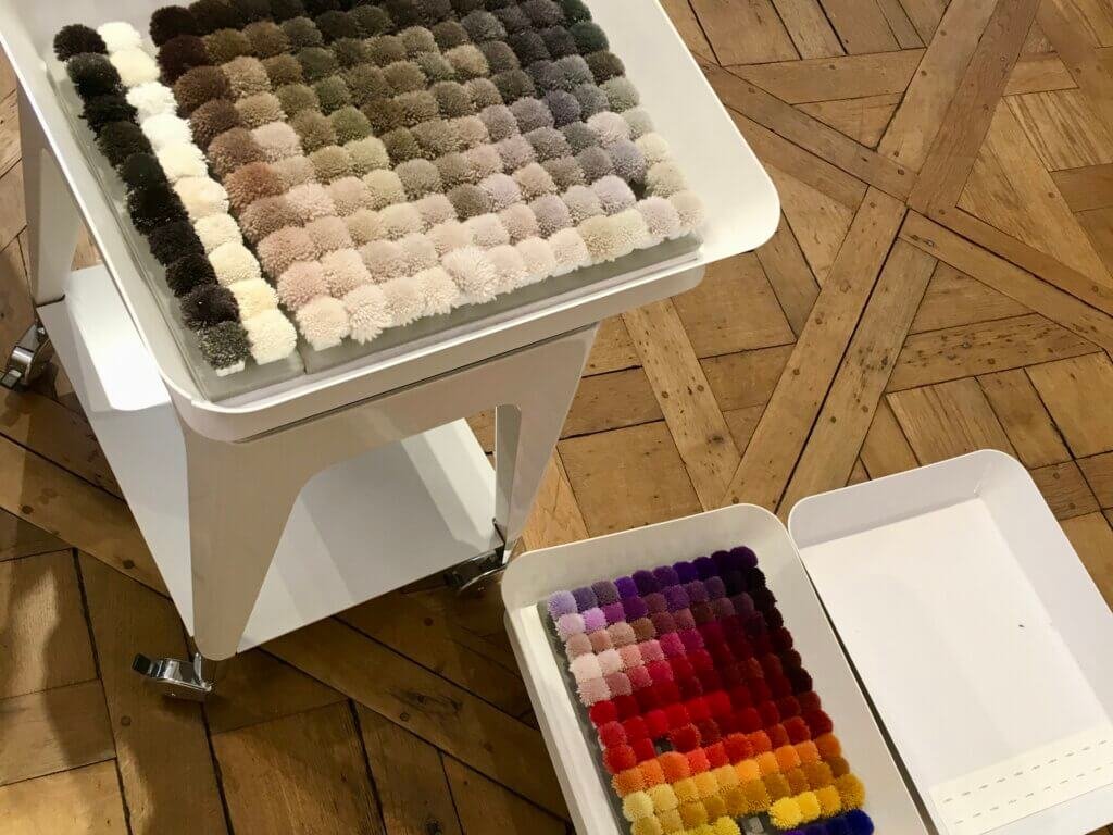 Interior design material samples in Paris, showing precise color and finish selection for international property renovation projects.