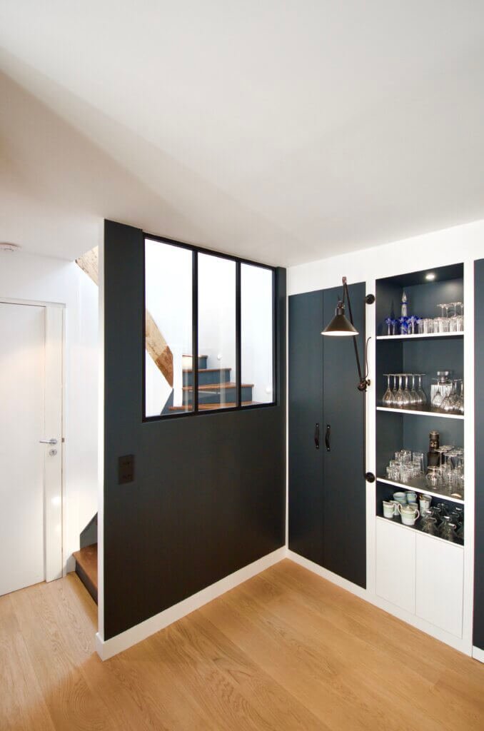 Duplex apartment in Paris 12e, circulation space with custom partition, staircase and integrated storage, client-side representation.