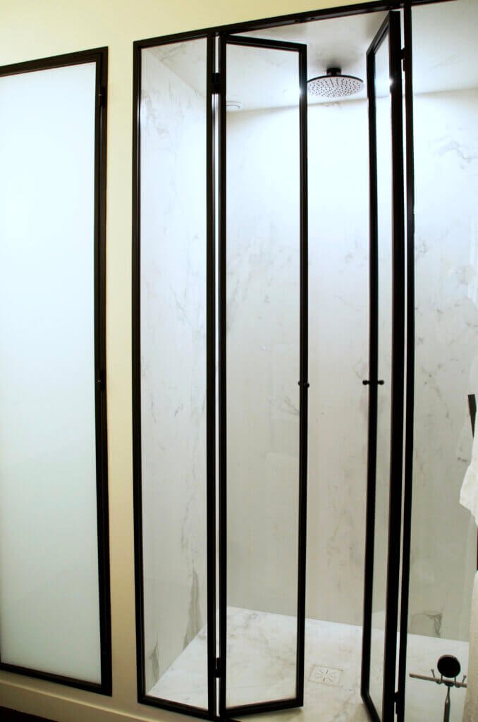 Marble shower room with bespoke glass doors