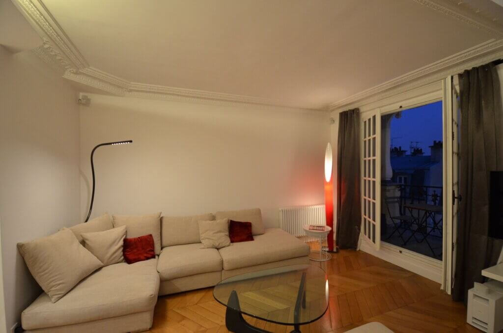 Living room arranged for reception and everyday use in a Paris pied-à-terre